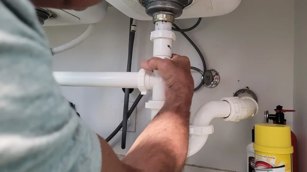 handyman at home tightening seals on plumbing pipe 2023 11 27 05 11 26 utc